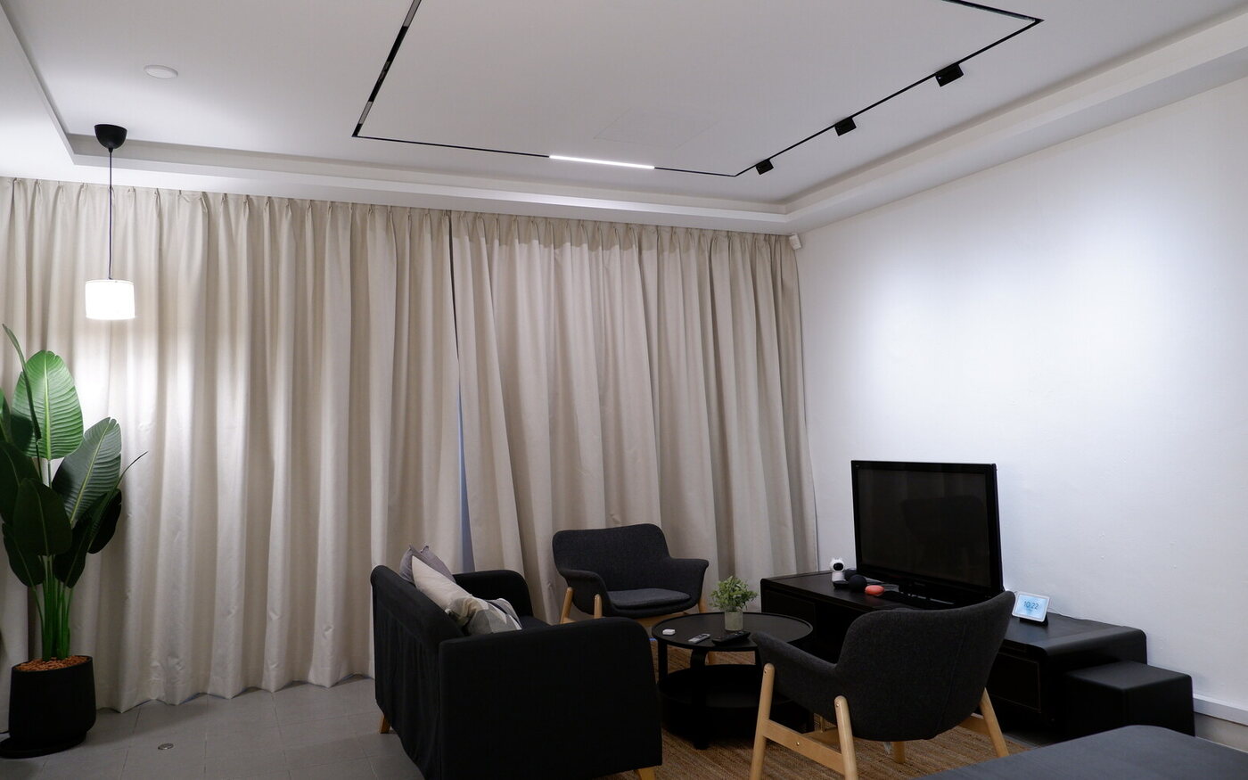 Smart lighting and motorised curtains in a Singapore HDB living room