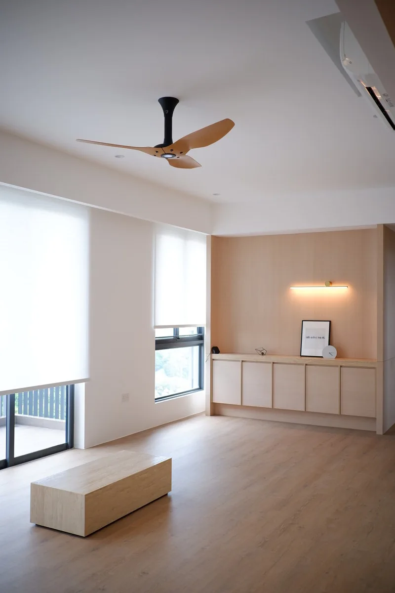 Open living space with a timber ceiling fan, wall lighting and built-in cabinetry